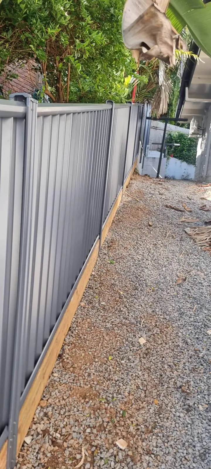 Black Colorbond fence on concrete sleeper wall