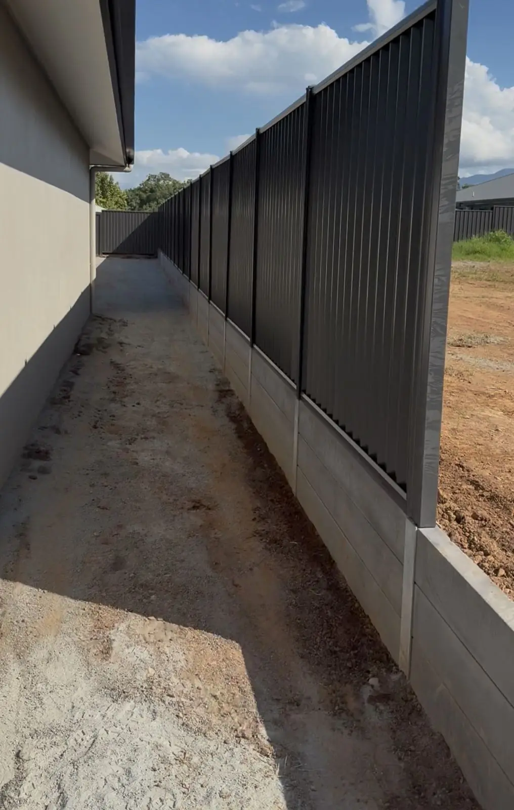 Colorbond fence on a concrete sleeper retaining wall