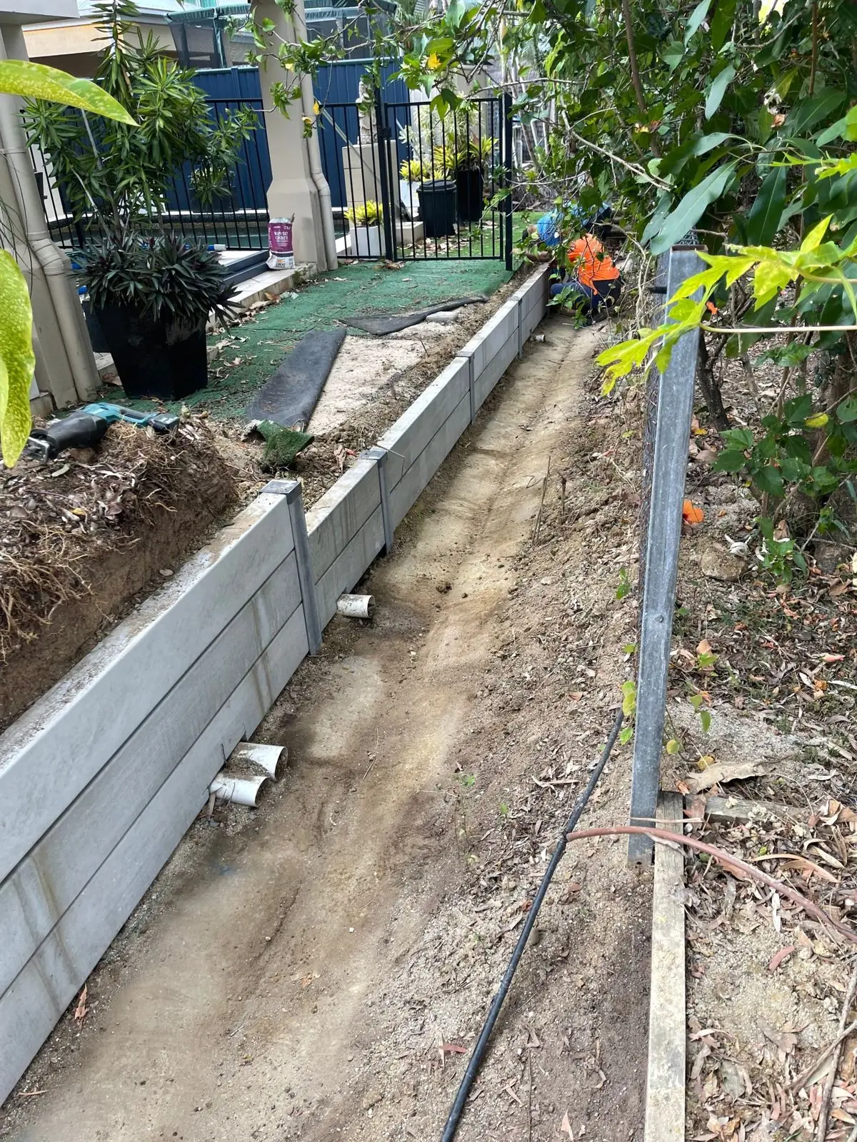 Finished wall with drainage outlets along a side path