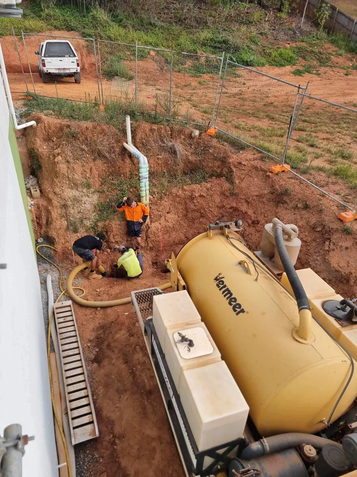 Crew using a vacuum excavation truck to locate services before drainage works