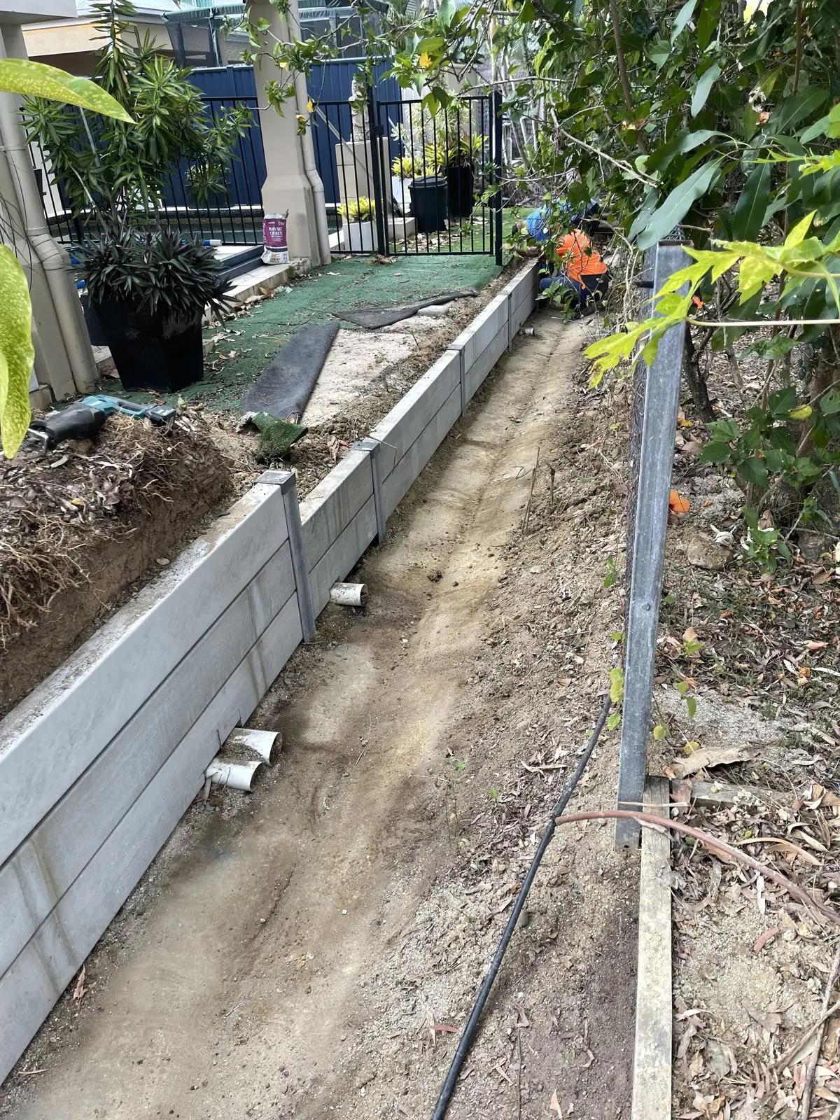 Drainage trench along an easement retaining wall