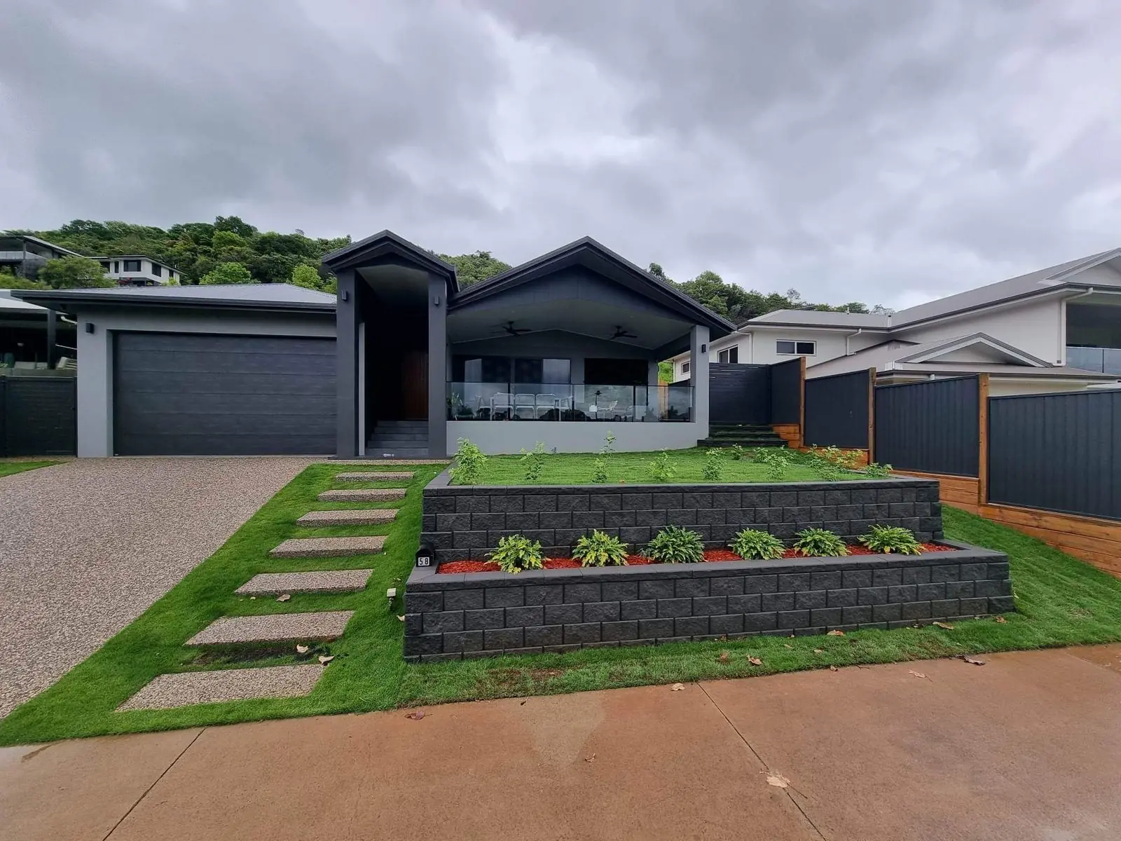 Finished front yard with block walls, turf and stepping pads