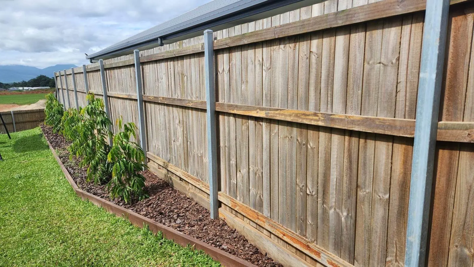 New garden bed along a paling fence