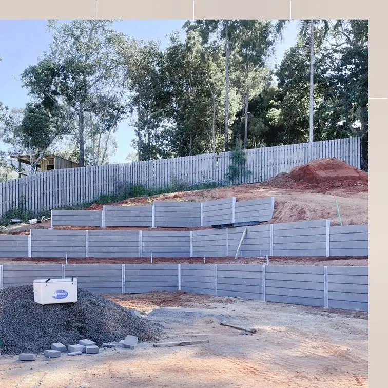 Tiered concrete sleeper walls under construction